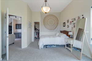 Carpeted bedroom with vaulted ceiling