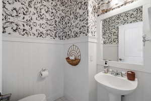 Bathroom with tile patterned floors, sink, and toilet