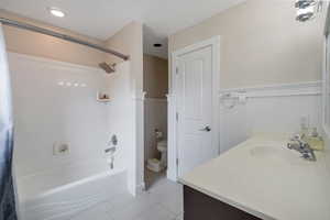 Full bathroom featuring vanity, bathtub / shower combination, toilet, and tile patterned flooring