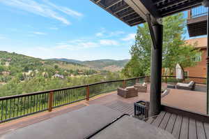 Wooden deck with outdoor lounge area and a mountain view