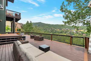 Wooden deck featuring a mountain view and an outdoor living space