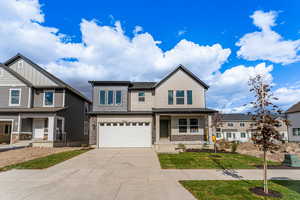 View of front of house featuring a garage and a porch