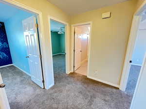 Corridor featuring carpet flooring