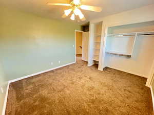 Unfurnished bedroom with a closet, carpet floors, and ceiling fan