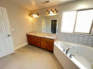 Bathroom featuring tile patterned flooring and double vanity