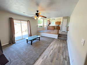 Interior space featuring hardwood / wood-style flooring, a textured ceiling, and ceiling fan