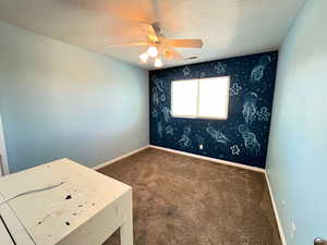 Unfurnished bedroom with carpet and ceiling fan