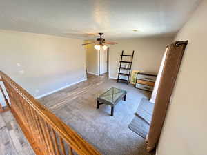 Living room featuring hardwood / wood-style floors and ceiling fan