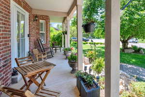 Cozy covered porch with plenty of shade from the mature tree!