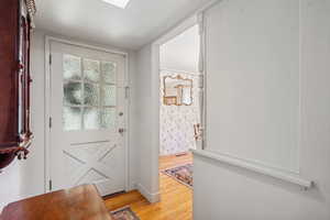 Doorway with light hardwood / wood-style floors