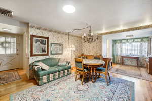 Dining area featuring a chandelier, wood-type flooring, and a wealth of natural light