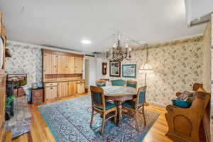 Dining room with an inviting chandelier and light hardwood / wood-style floors