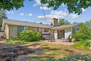 Rear view of property featuring central air condition unit and a patio area