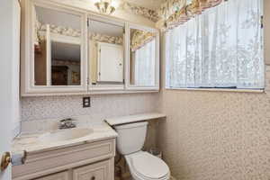 Bathroom featuring vanity and toilet