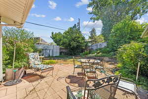 View of patio featuring a storage unit