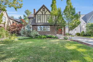 Tudor home with a front yard