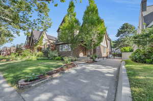 Tudor-style house with a front yard