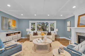 Living room with light hardwood / wood-style flooring and coffered ceiling