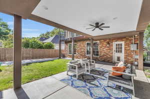 View of patio with outdoor lounge area and ceiling fan