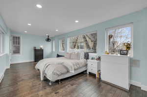 Sunroom featuring dark hardwood / wood-style flooring and multiple windows