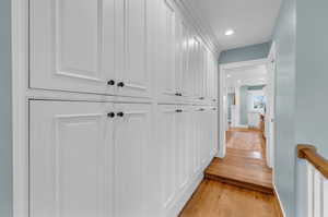 Hallway with light hardwood / wood-style flooring