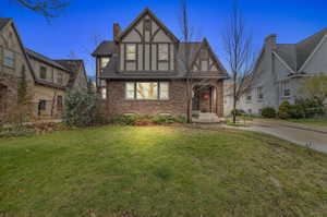 Tudor-style house featuring a front lawn