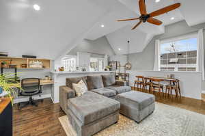 ADU Living room featuring vaulted ceiling, ceiling fan, wood-type flooring, and a healthy amount of sunlight