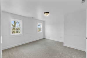 Upstairs Carpeted empty room with plenty of natural light