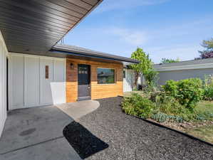 Doorway to property featuring a patio area