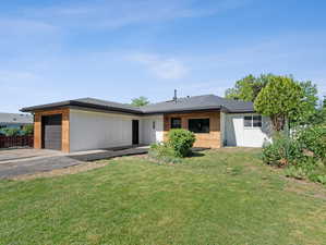 Ranch-style home with a garage and a front yard