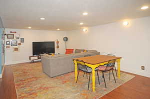 Dining area featuring wood-type flooring and a textured ceiling