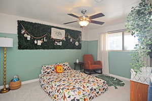 Carpeted bedroom with ceiling fan