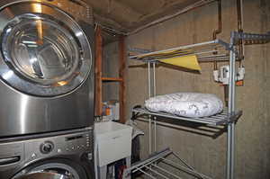 Laundry room with sink and stacked washer / dryer