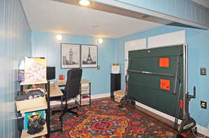 Office with a textured ceiling and hardwood / wood-style flooring