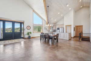 Dining room with concrete floors and high vaulted ceiling