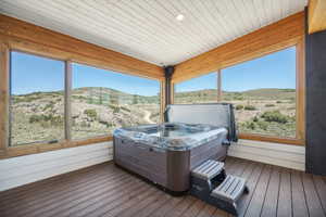 Sunroom / solarium featuring a mountain view and wooden ceiling