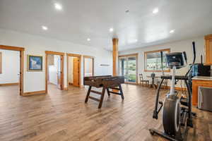 Interior space with french doors, ornate columns, and light hardwood / wood-style floors