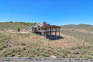 Exterior space with a gazebo, a deck with mountain view, and a rural view