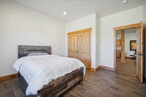 Bedroom with dark wood-type flooring