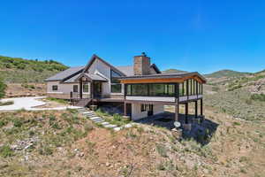 Rear view of property with a mountain view