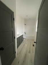 Bathroom featuring vanity, toilet, and hardwood / wood-style floors