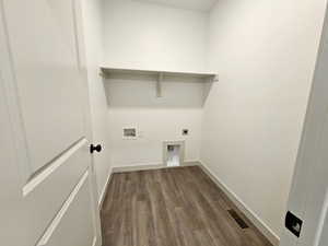 Washroom featuring washer hookup, electric dryer hookup, and dark wood-type flooring