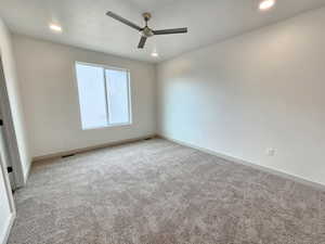 Empty room with carpet and ceiling fan