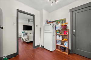 Interior space featuring dark hardwood / wood-style flooring, ornamental molding, and ceiling fan