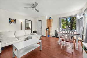 Living room featuring dark hardwood / wood-style floors and ceiling fan