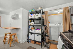 Interior space with washing machine and dryer and a textured ceiling