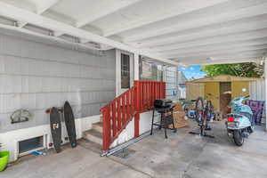 View of patio / terrace with area for grilling and a shed