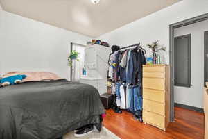 Bedroom with hardwood / wood-style flooring