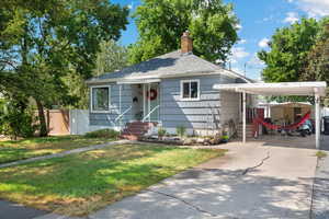 Bungalow-style house featuring a carport and a front yard