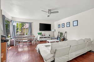 Living room with ceiling fan and wood-type flooring